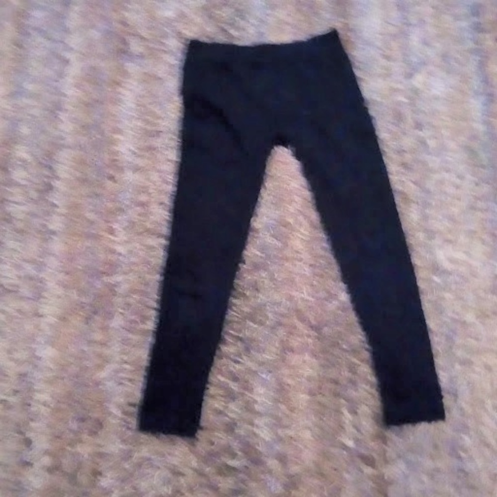 Black leggings with ruffles on sides.